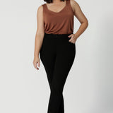 Petite height model wears black cropped pants. The Corbin Pants are perfect workwear pants made of Black Scuba Crepe. This off duty pant style is breathable and stretchy.  Australian made for Australian and New Zealand women. Leina & Fleur actively stock sizes 8-24 including plus & petite sizes. 