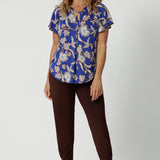 A good summer top with flutter sleeves for over 50s women, the relaxed fit of this jersey top looks good with espresso brown tapered leg travel pants. With a holiday print and in lightweight, easy care jersey, this is the perfect top for travel and cruise wear. Made in Australia by Australian and New Zealand women's clothes label, Leina & Fleur shop plus size tops online.