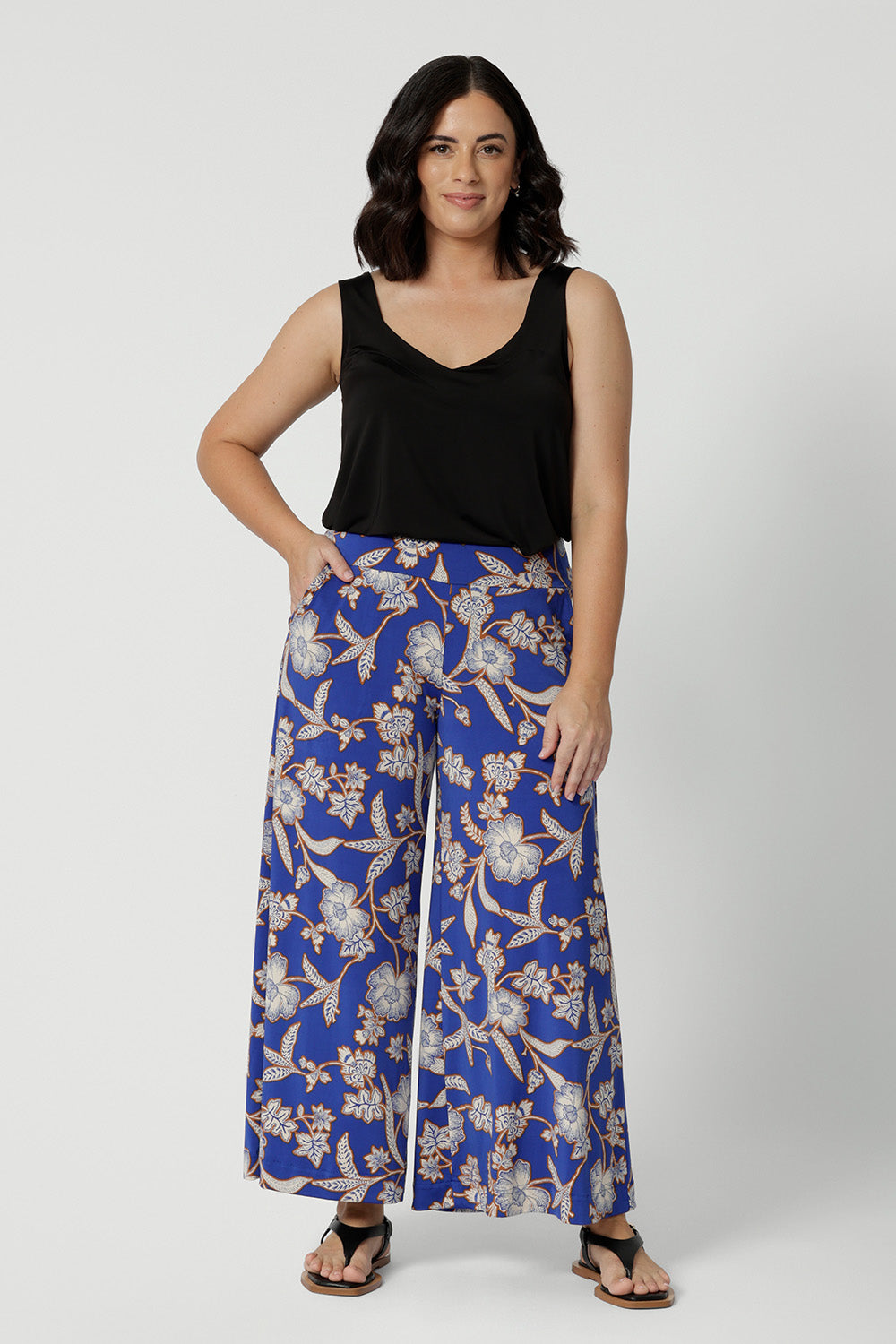 Wide leg pants for summer don't come much better than this! Worn by a size 10, woman, these petite friendly wide leg pants are in easy care jersey with a blue, caramel and white floral print. Made in Australia by Australian and New Zealand womens clothing brand, Leina and Fleur. Shop wide leg pants in petite to plus sizes.