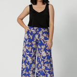 Wide leg pants for summer don't come much better than this! Worn by a size 10, woman, these petite friendly wide leg pants are in easy care jersey with a blue, caramel and white floral print. Made in Australia by Australian and New Zealand womens clothing brand, Leina and Fleur. Shop wide leg pants in petite to plus sizes.