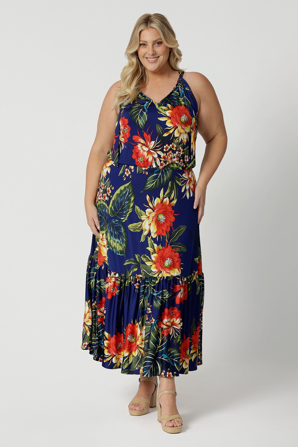 Full body image of plus sized woman wearing maxi dress. Travel ready dress is made of easy care slinky jersey fabric. This maxi dress is perfect for any travel capsule. Designed in Australia for Australian and New Zealand women. Leina & Fleur is a womans clothing brand that stock sizes from 8 to 24. Shop this summer ready dress in petite sizes and plus sizes.