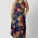 Full body image of plus sized woman wearing maxi dress. Travel ready dress is made of easy care slinky jersey fabric. This maxi dress is perfect for any travel capsule. Designed in Australia for Australian and New Zealand women. Leina & Fleur is a womans clothing brand that stock sizes from 8 to 24. Shop this summer ready dress in petite sizes and plus sizes.