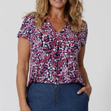 As an off-duty top or a work wear top for women, this V-neck top with tailroed tuck is a comfortable top for women.  A woman with over 40s style   wears short sleeve V-neck jersey top. New Zealand women's clothes brand, Leina & Fleur, shop their petite to plus size tops online. 