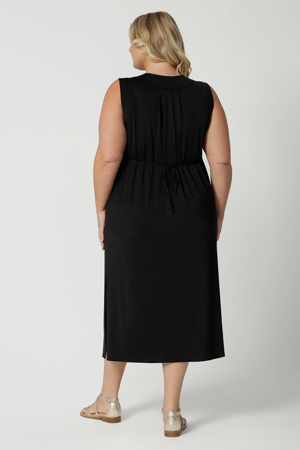 Back view of a women's plus size black jersey dress  Shown on a size 18, this sleeveless black dress is made in Australia by Australian and New Zealand women's fashion brand, L&F. Shop plus size summer dresses Australia online in size 8 to 24.