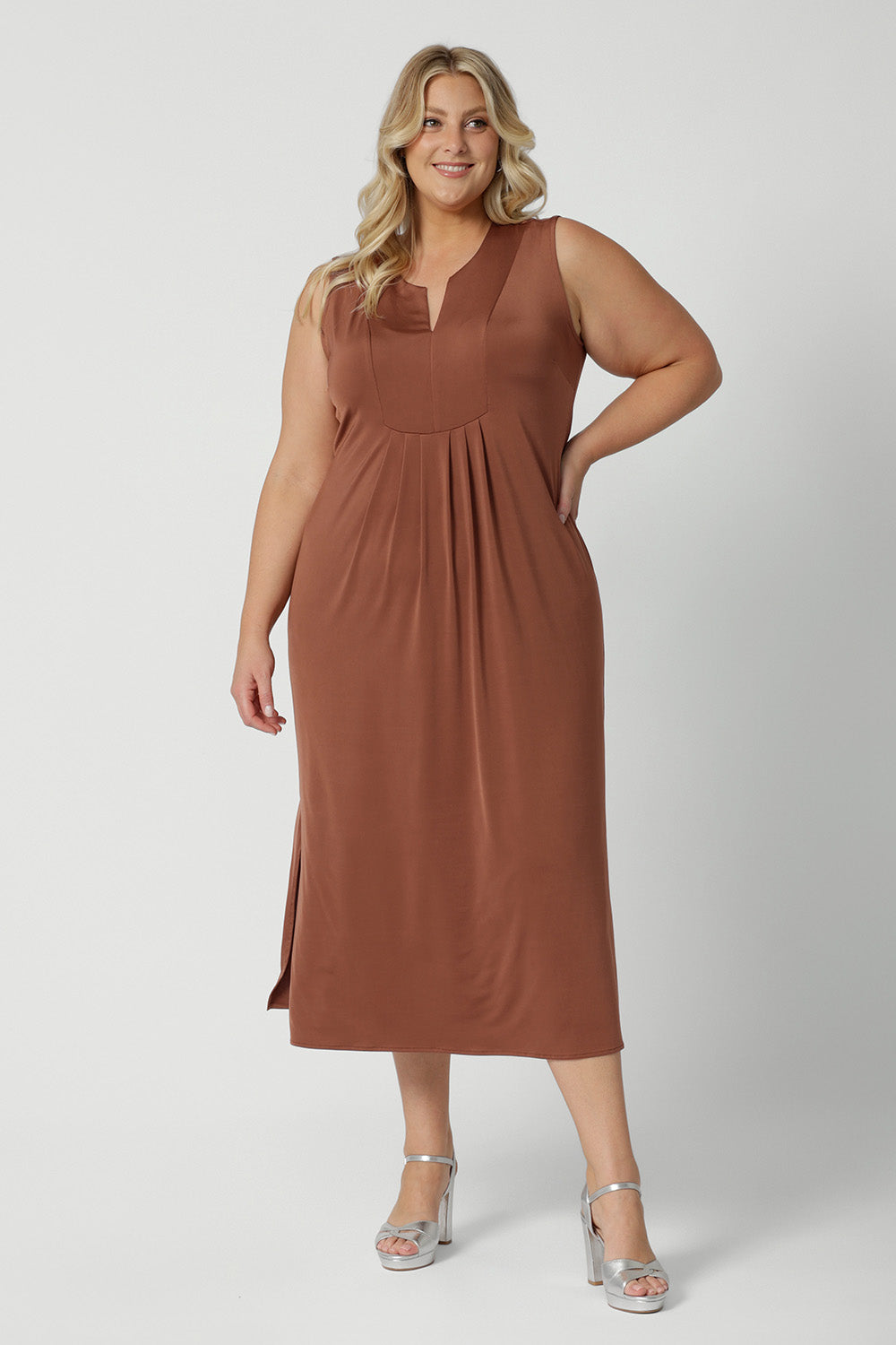 A good plus size sleeveless dress in clay coloured slinky jersey fabric. A dress for curvy women, it's made in Australia by Australian and New Zealand women's clothing brand, Leina & Fleur, this flattering empire line midi dress is made for plus size women, available in sizes 16 to 24. Perfect for showing off curves with a comfortable fit.