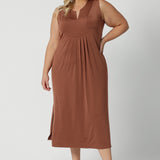 A good plus size sleeveless dress in clay coloured slinky jersey fabric. A dress for curvy women, it's made in Australia by Australian and New Zealand women's clothing brand, Leina & Fleur, this flattering empire line midi dress is made for plus size women, available in sizes 16 to 24. Perfect for showing off curves with a comfortable fit.