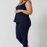 Side view of a  good loungewear pant for curvy women. These navy bamboo tapered leg,  plus size pants are pull-on pyjama pants. Worn with navy bamboo cami top, this is a breathable, thermo-regulating pyjama set and makes get sleepwear for night sweats and hot flushes. Shop loungewear sets online at L&F Australia.