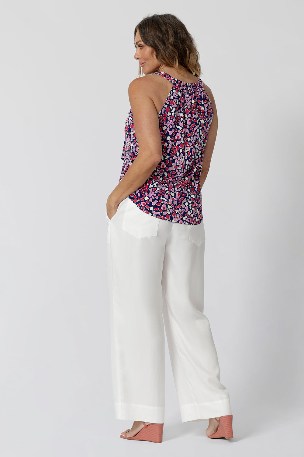 BAck view of  a summer top for over 40s women. This halter neck top is a comfortable, easy-care top worn with white pants for summer.  In red, pink, white and navy print, this slink jersey top is a made in Australia top by Australian and New Zealand women's clothes brand, Leina & Fleur, shop their petite to plus size tops online. 