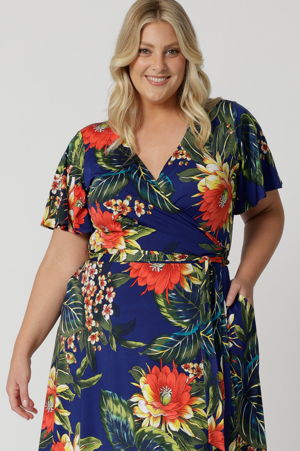 This easy care and crease resistant dress is perfect for travel. Printed dress has a colourful combination of orange, yellow and white flowers on a deep blue base. Designed in Australia with easy care fabric for Australian and New Zealand woman. Sizes 8-24.