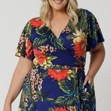 This easy care and crease resistant dress is perfect for travel. Printed dress has a colourful combination of orange, yellow and white flowers on a deep blue base. Designed in Australia with easy care fabric for Australian and New Zealand woman. Sizes 8-24.