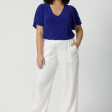 These white summer pants are crafted from lightweight lyocell fabric, perfect for staying cool in the Australian heat. Designed with a wide leg silhouette, they offer a relaxed and breezy fit. Ideal choice for casual outings or beach days. Made in Australia, these pants combine style and comfort, showcasing quality craftsmanship that celebrates local production. Leina & Fleur stock sizes 8-24.