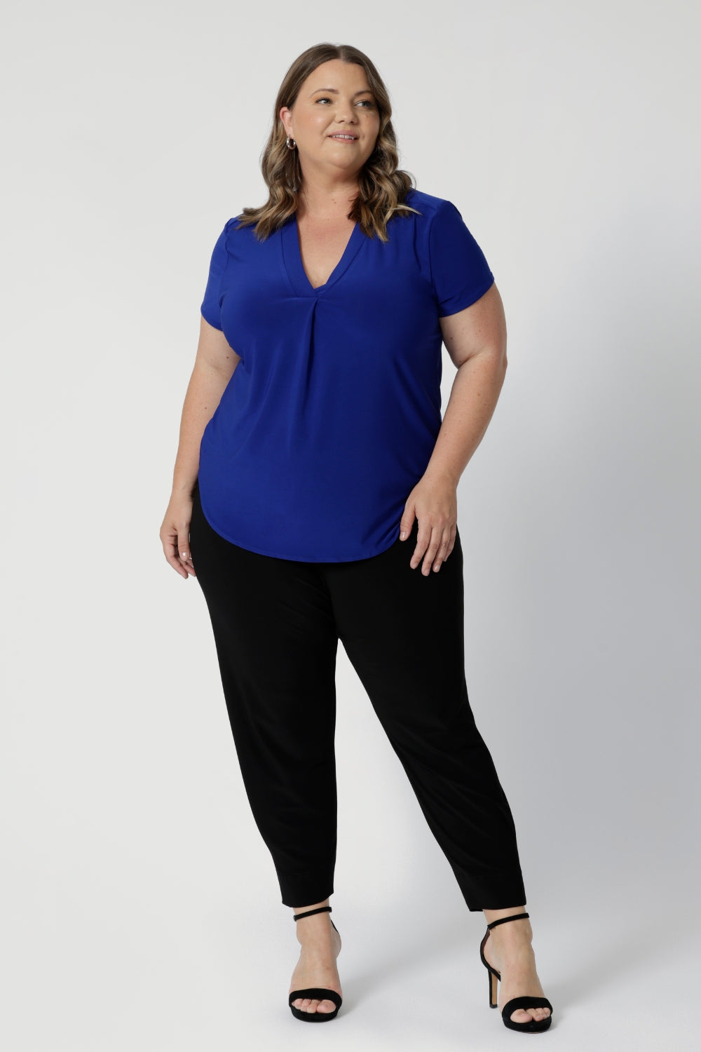 The design of the top is flattering and plus-size friendly, tailored to provide an elegant fit for curves without feeling tight or restrictive. The cut ensures ease of movement while maintaining a clean, streamlined silhouette. A modest neckline, such as a subtle scoop or crew neck, gives it a refined look, while three-quarter sleeves offer a versatile and comfortable option for year-round wear.