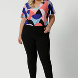 Image of plus sized woman wearing black work wear pants. The Corbin Pant is made of stretchy black Scuba Crepe fabric. This off duty pant style is breathable and has a matching black blazer to complete the full suit look.  Made in Australia by Leina & Fleur, a woman's clothing brand that stocks sizes 8-24.