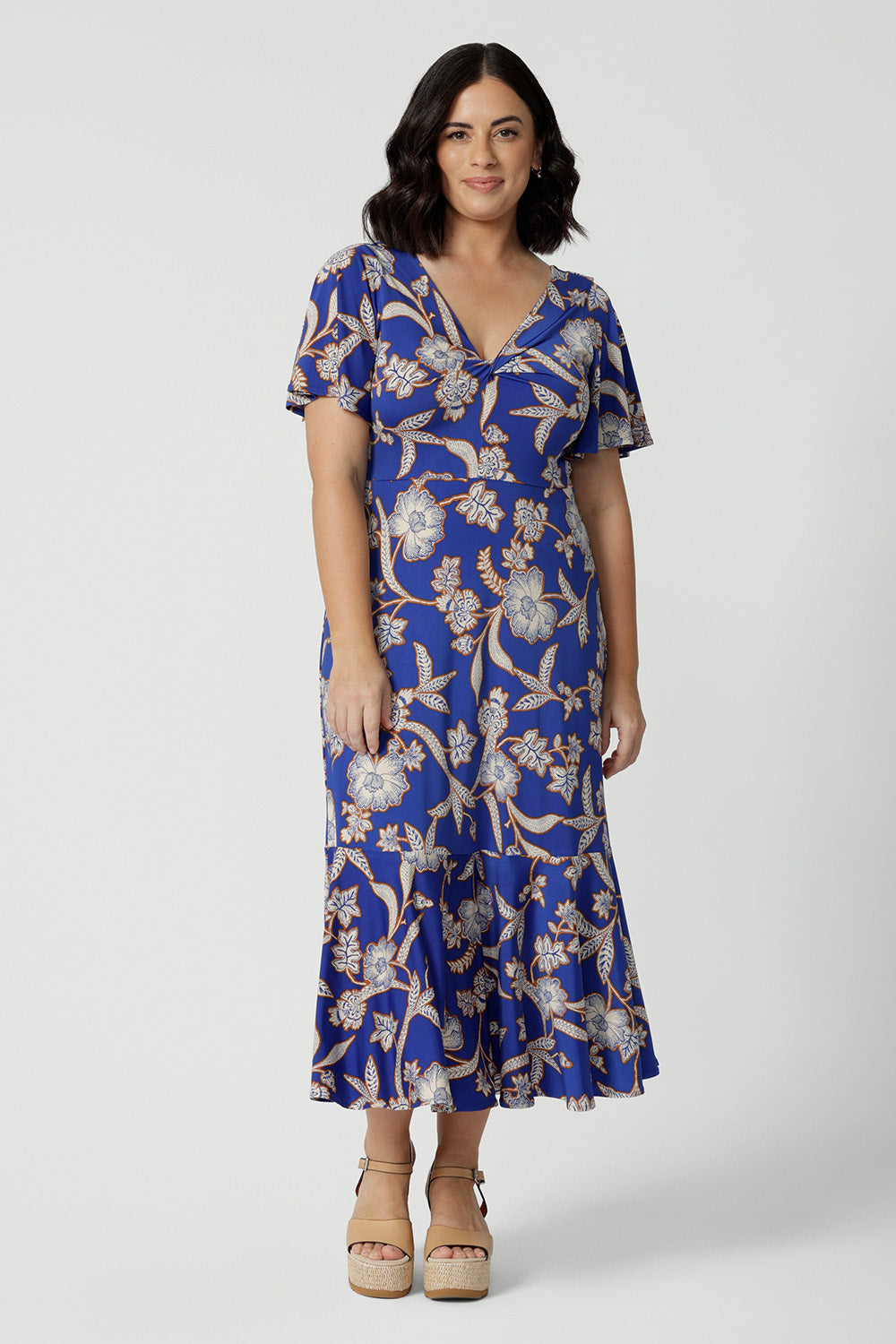 A good empire line dress for petite height women, this twist front jersey dress in size 10 has flutter sleeves and a ruffle hem. A blue dress with floral print, be holiday ready with this travel and cruise wear dress style. Made in Australia by Australian and New Zealand womens clothing brand, Leina & Fleur, shop their petite to plus sizes dresses online.