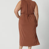 Back view of a good plus size sleeveless dress in clay coloured slinky jersey fabric. A dress for curvy women, it's made in Australia by Australian and New Zealand women's clothing brand, Leina & Fleur, this flattering empire line midi dress is made for plus size women, available in sizes 16 to 24. Perfect for showing off curves with a comfortable fit.