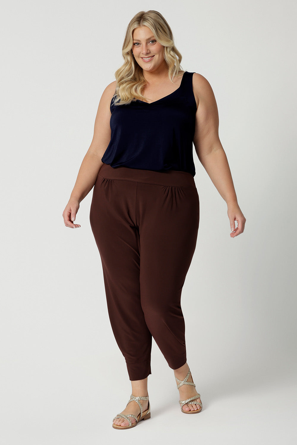 Good travel pants for curvy, plus size women. These tapered leg pants by Australian and New Zealand women's  clothing brand, Leina & Fleur are comfortable stretchy pants in espresso brown jersey fabric. Shop travel pants for plus size women online in sizes 8 to 24.