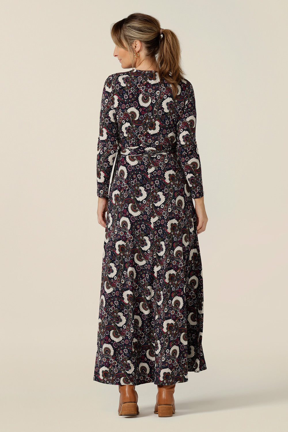 Back view of a maxi dress by Australian and New Zealand women's clothing label, L&F. The Kimberley maxi dress has long sleeves, pockets and a V-neck. This full-length, wrap dress comes in paisley print jersey. Designed for fashionable 40 plus women, shop dresses now in sizes 8 to 24.
