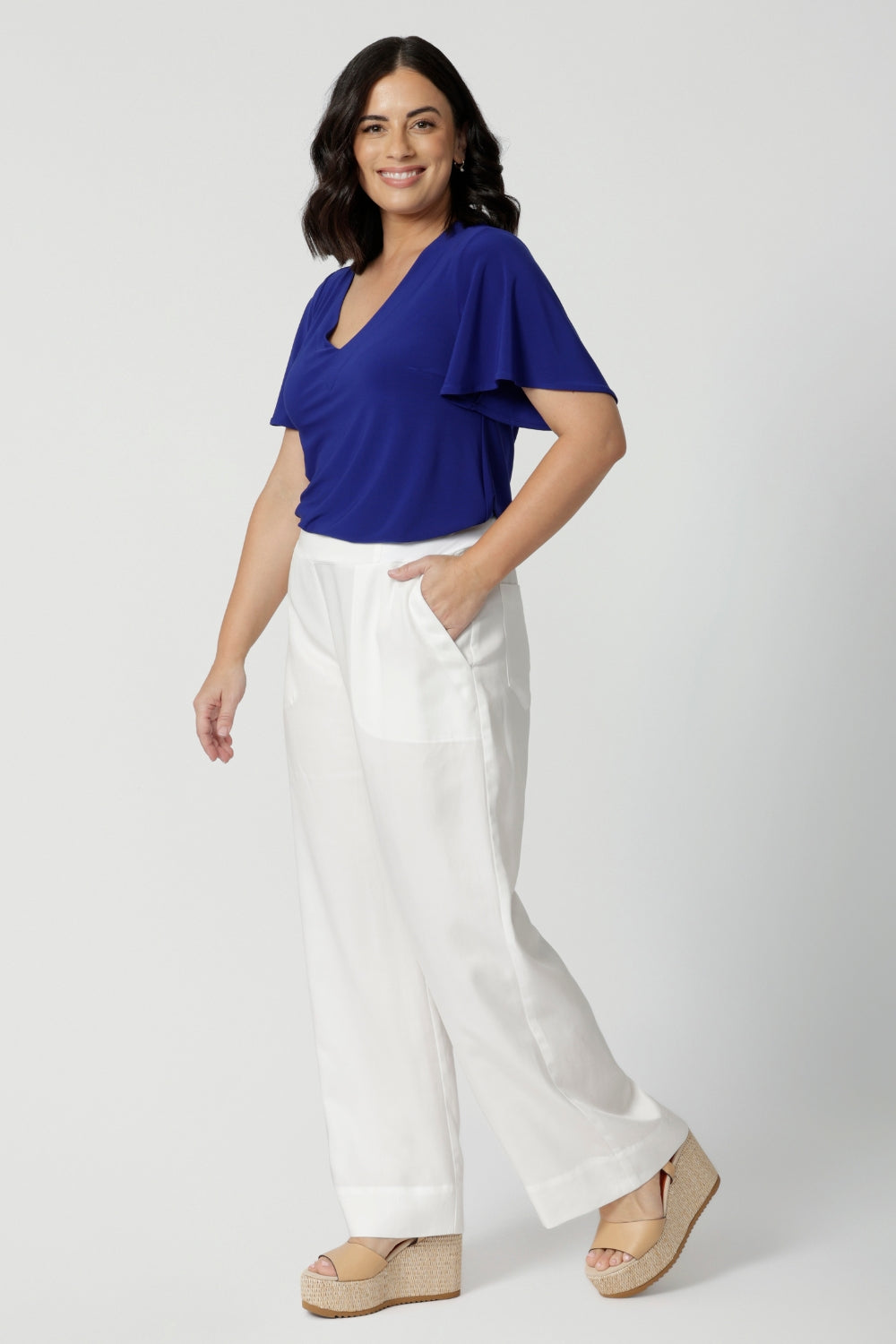 Full body image of petite woman wearing casual wide leg pants. Lightweight lyocell fabric pant is perfect for staying cool in the Australian heat. Designed with a wide leg, these light weight pants offer a relaxed and breezy feel. Versatile pants can be worn for casual outings or beach days. Australian made with quality craftsmanship that celebrates local production and sustainability. Woman's fashion label Leina & Fleur stock sizes 8-24.