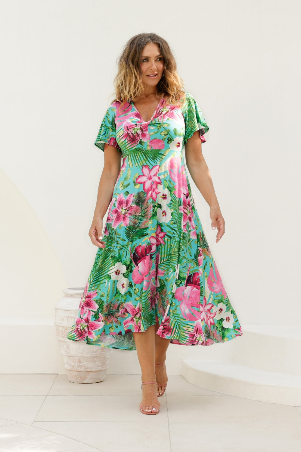 The Milly Dress in Malibu is a midi length dress adds a touch of elegance to your wardrobe. The high-low hem gives it a modern, breezy feel, and its vibrant floral print exudes a carefree, tropical vibe, ideal for beachside resorts or casual summer outings. Made in Australia, it combines quality craftsmanship with a laid-back, sophisticated style that’s perfect for warm-weather adventures.