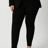 Close up image of pants worn by plus sized model. Easy care pants are made from scuba crepe fabric that provide comfortability and stretch when worn. Image shows pants styled with blazer for a full suiting look. Woman's clothing brand Leina & Fleur is Australian made and have a size offering of 8-24.