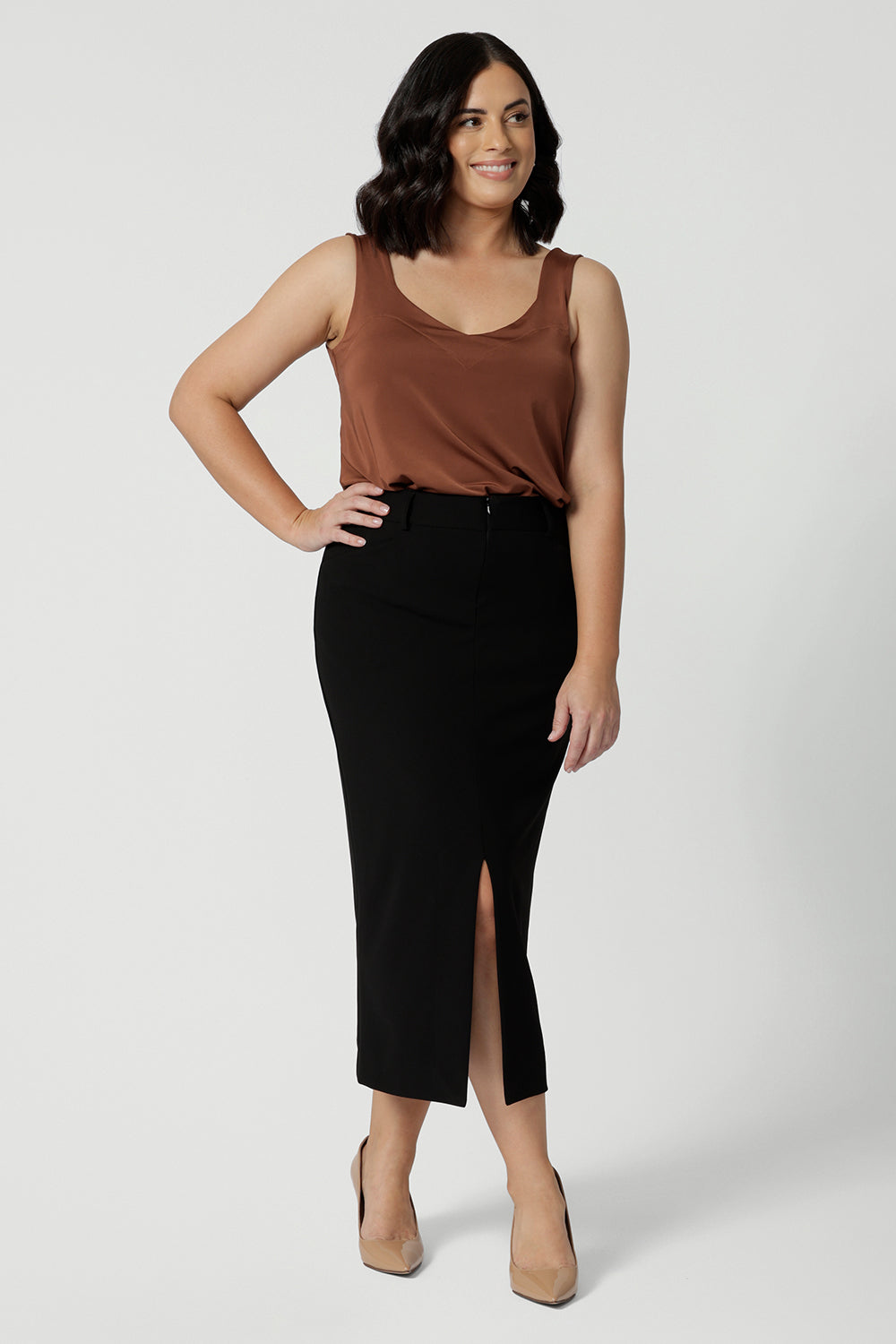 Petite- friendly, straight-cut black midi skirt in lightweight scuba crepe jersey, designed by Australian and New Zealand women's clothing brand, Leina & Fleur. This stretchy, easy-care skirt is a perfect skirt for petite women, an ideal as both a workwear skirt and off duty skirt.