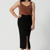 Petite- friendly, straight-cut black midi skirt in lightweight scuba crepe jersey, designed by Australian and New Zealand women's clothing brand, Leina & Fleur. This stretchy, easy-care skirt is a perfect skirt for petite women, an ideal as both a workwear skirt and off duty skirt.