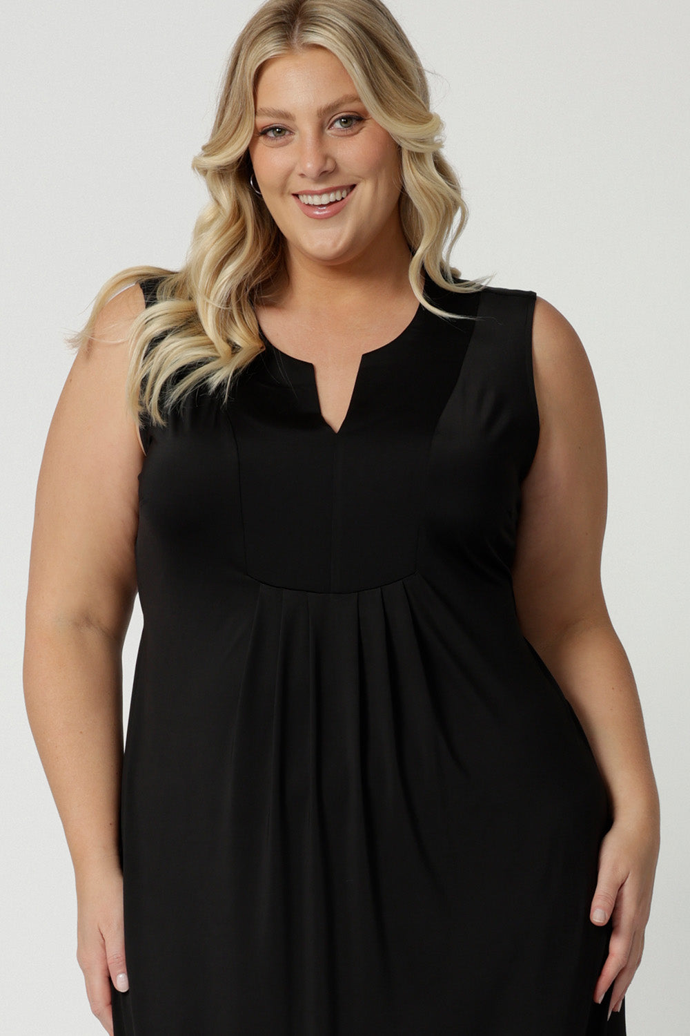 Close up of the bodice of a plus size empire line black dress  Shown on a size 18, this sleeveless black dress is made in Australia by Australian and New Zealand women's fashion brand, L&F. Shop plus size event dresses Australia online in size 8 to 24.