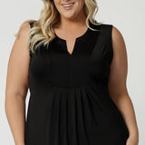 Close up of the bodice of a plus size empire line black dress  Shown on a size 18, this sleeveless black dress is made in Australia by Australian and New Zealand women's fashion brand, L&F. Shop plus size event dresses Australia online in size 8 to 24.