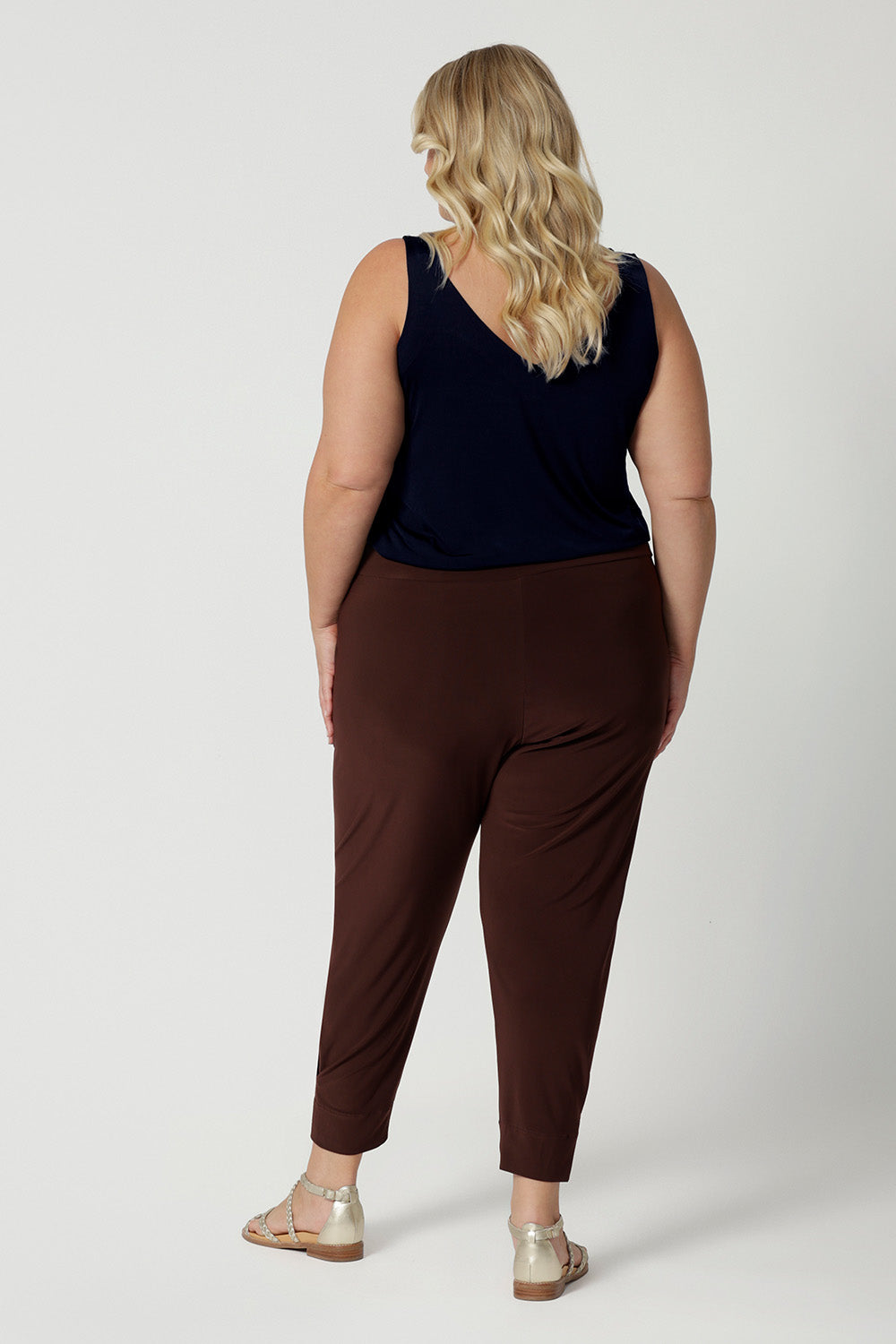 Back view of Australian-made travel pants for curvy, plus size women. These tapered leg pants by Australian and New Zealand women's  clothing brand, Leina & Fleur are comfortable stretchy pants in espresso brown jersey fabric. Shop travel pants for plus size women online in sizes 8 to 24.