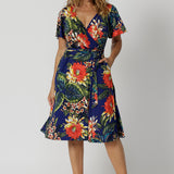 The Maggie Knee Length Dress in Bahagia is perfect for cruise holidays and resort style. This wrap dress style is crafted with quality and local craftsmanship. This floral jersey fabric is easy-care and crease-resistant. Leina & Fleur stock sizes in sizes 8 to 24. Shop wrap dresses online.