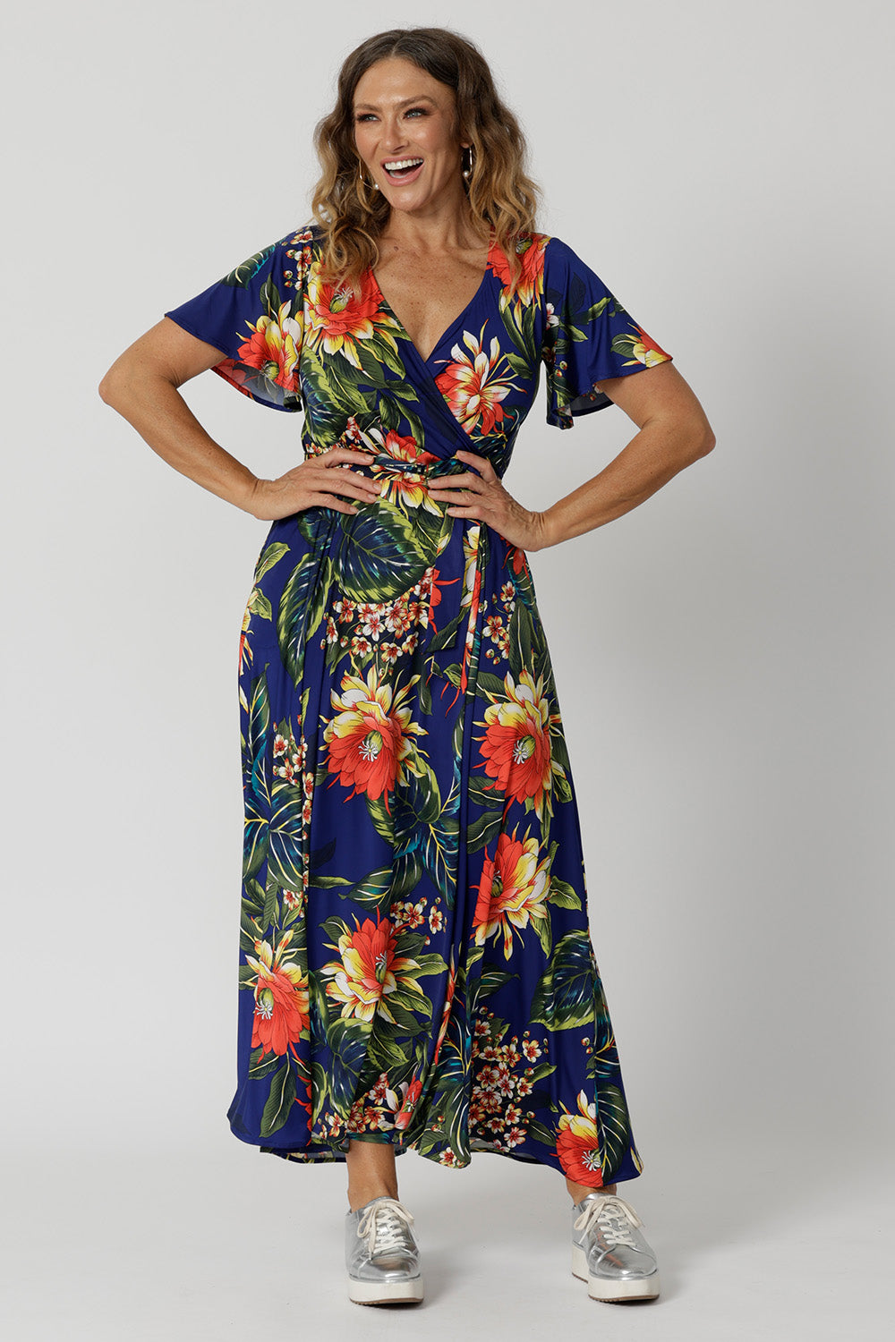 A good maxi dress for summer worn by sizes 12 model. This printed jersey dress has functioning wrap dress design. A dress for cruise holidays and resort style. This maxi dress is easy-care and crease-resistant, perfect for travel. Made in Australia for Australian and New Zealand women. Fashion brand Leina & Fleur have sizes  in 8 to 24. Shop resort ready styles online now.