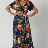 A good maxi dress for summer worn by sizes 12 model. This printed jersey dress has functioning wrap dress design. A dress for cruise holidays and resort style. This maxi dress is easy-care and crease-resistant, perfect for travel. Made in Australia for Australian and New Zealand women. Fashion brand Leina & Fleur have sizes  in 8 to 24. Shop resort ready styles online now.