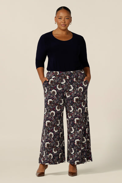 A size 18, fuller figure woman wears pull-on wide leg jersey pants by Australian and New Zealand women's clothing brand, L&F. Comfortable trousers for work wear and casual wear, these printed pants are made in Australia in sizes 8 to 24.