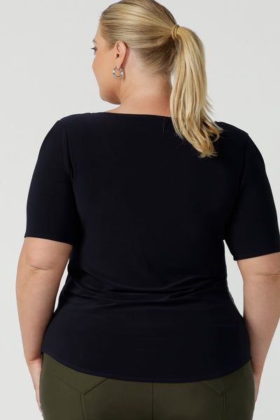 back view of a good top for plus size, curvy women. This short sleeve, boat neck top in navy blue is shown on a size 18. A quality top for workwear, this slim fit jersey top is made in Australia by women's clothing brand, Leina & Fleur.