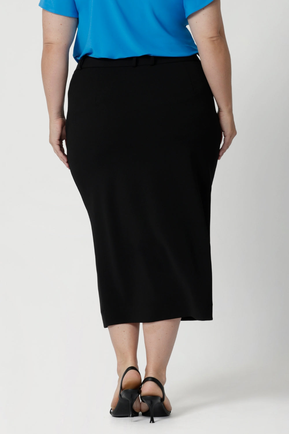 Back view of stretchy, easy-care skirt is a perfect workwear piece for elevated suit styling with matching jacket or blazer. Australian made of scuba crepe jersey in sizes 8-24.