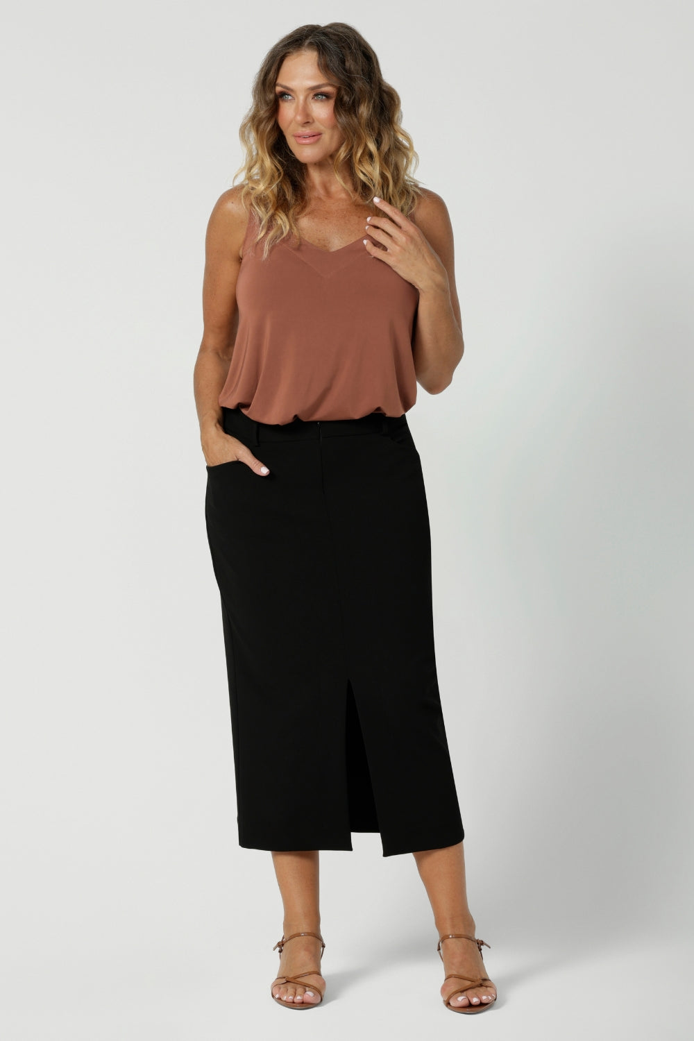 Great for over 40s women's style, 
this straight-cut black midi skirt in lightweight scuba crepe jersey. Made in Australia by Australian and New Zealand women's clothing brand, Leina & Fleur. This stretchy, easy-care skirt is a perfect workwear piece for elevated styling.