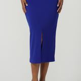 Back view of a size 10 woman wears the Aaron Mid Skirt in Cobalt Crepe back with the Black Ziggy Top. Made in Australia for women size 8-24. Comfortable corporate wear for women. Suit Sets in Cobalt. Easy care material. Petite to Plus Size women.