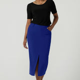 A size 10 woman wears the Aaron Mid Skirt in Cobalt Crepe back with the Black Ziggy Top. Made in Australia for women size 8-24.  Comfortable corporate wear for women. Suit Sets in Cobalt. Easy care material. Petite to Plus Size women. 