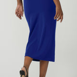 Back view of a size 10 woman wears the Aaron Mid Skirt in Cobalt Crepe back with the Black Ziggy Top. Made in Australia for women size 8-24. Comfortable corporate wear for women. Suit Sets in Cobalt. Easy care material. Petite to Plus Size women.