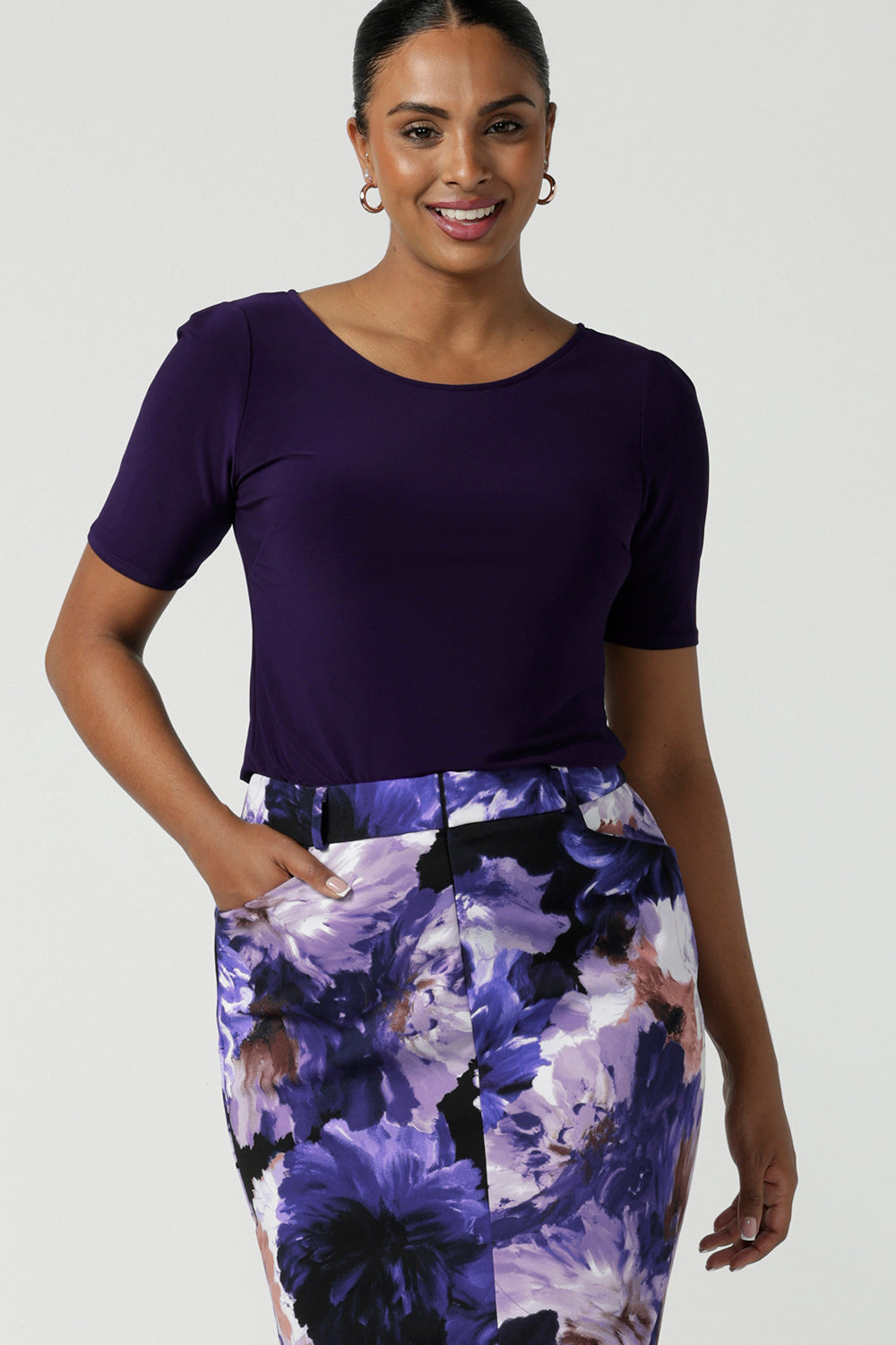 A size 10 woman wears the Ziggy Amethyst Top with boat neckline made in comfortable easy care jersey. Comfortable workwear for women. Clothing for petite to plus size women 8-24. 