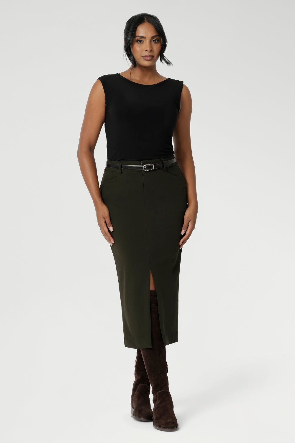 Image of Australian made Olive workwear skirt seen on over 30's woman paired with black boat neck top and brown boots for an elevated workwear look. Sizes 8-24 available at Leina & Fleur.