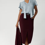 This women's workwear midi skirt in a stunning wine colour is made from a luxe, easy-care Scuba Crepe Jersey fabric, offering a soft textured feel and full body stretch for comfort and flexibility throughout your day.