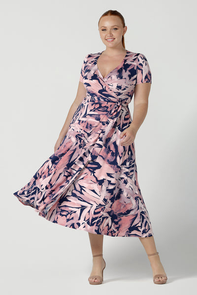 Size 12 woman wears the Alexis dress a functioning wrap dress with short sleeve and midi length. Great for work to weekend wear. Made in Australia for women size 8 - 24.