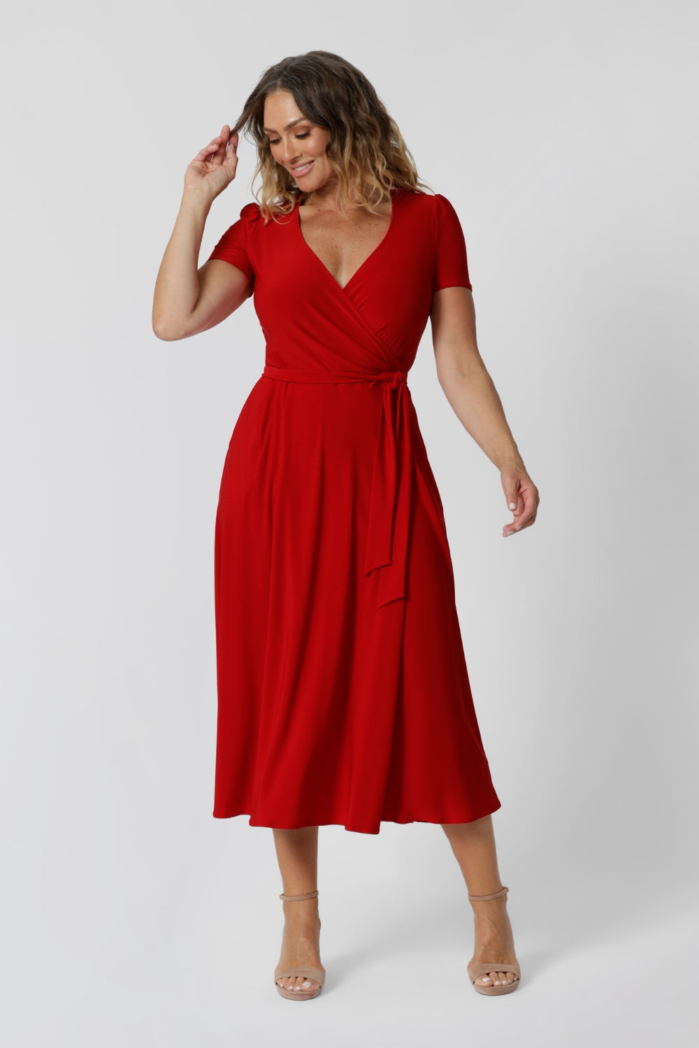 40 year old woman wears red wrap dress crafted from soft dry touch jersey fabric, making it both comfortable and stylish. Midi length dress, it’s perfect for any occasion, especially during the festive season when red is the standout colour. Fashion brand Leina & Fleur stock sizes 8-24.