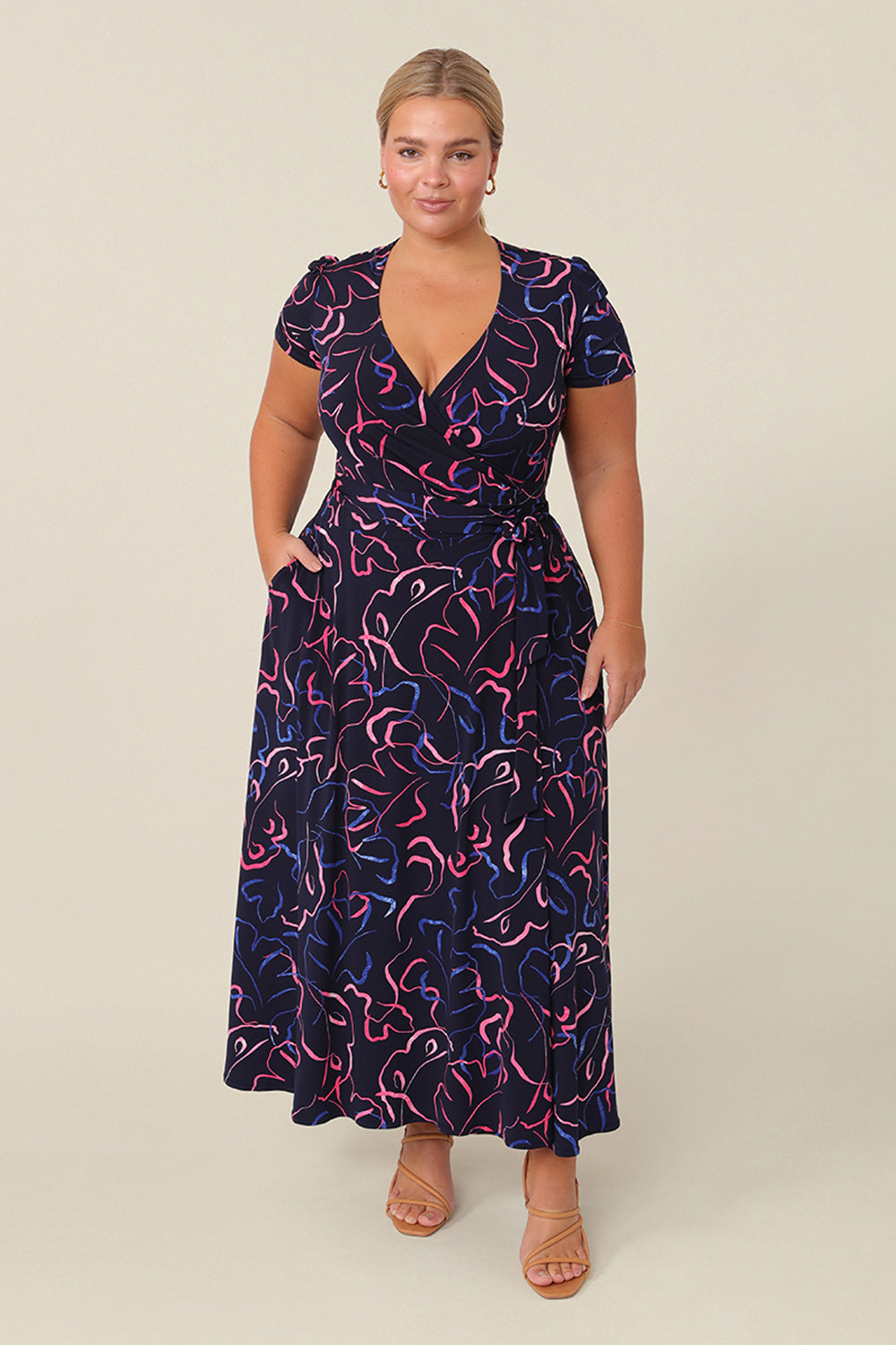 A petite height, size 16 woman wears a good midi length dress. The Alexis Dress in Silhouette is a functioning wrap dress, great for an occasion. This women’s dress is made in Australia in sizes 8 to 24.