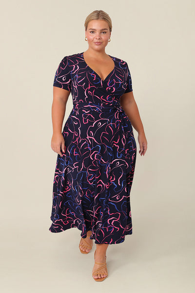 Shown for petite height women, this is a printed wrap dress with short sleeves. With a full, midi skirt, this jersey dress is a good dress for evening and occasion wear. Made in Australia, shop dresses in sizes 8 to 24.