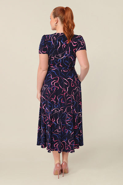 Back view of an Australian-made, printed jersey, wrap dress with short sleeves. A great weekend dress, this wrap dress is styled with heels as an elegant event dress.