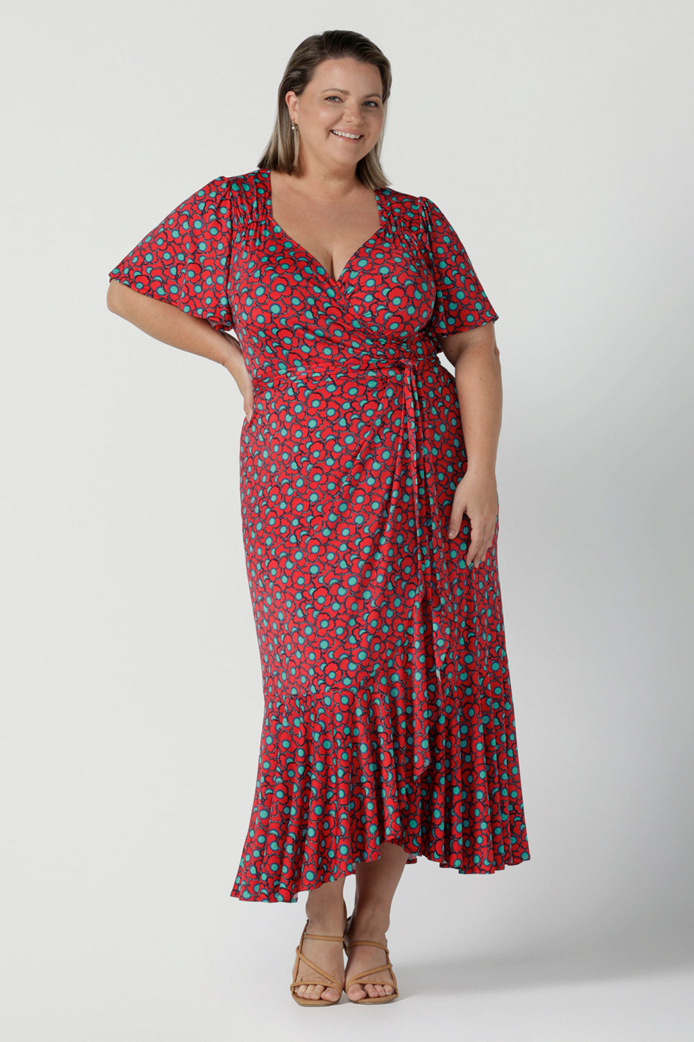 Women's Wrap dress in soft slinky jersey. The beautiful Rio print has seventies inspired florals with aqua.Romantic valentines day dressing, frill hem and flutter sleeve for curvy women size 8 - 24.