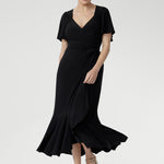 Women’s black wrap dress featuring sweetheart neckline, waist ruching, and flutter sleeves, Alita Dress for luxe evening style.