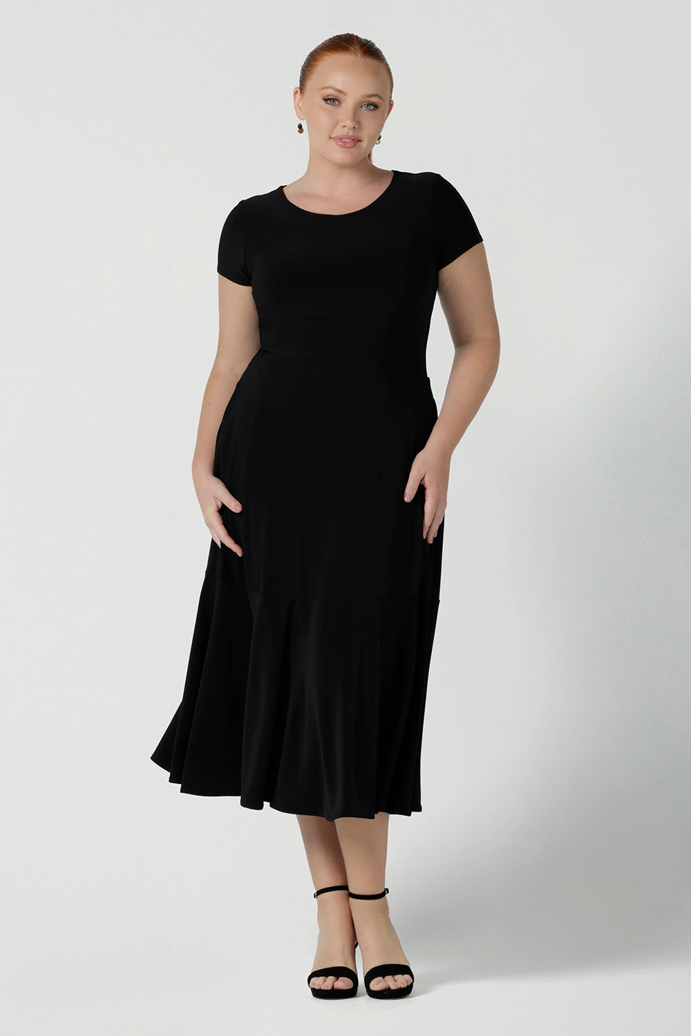 The Amal dress in black is a slim fit round neck dress with waist seam and tier at the bottom. Functioning pockets. Great for work or event occasions. Made in Australia. Size inclusive fashion for women size 8 - 24.